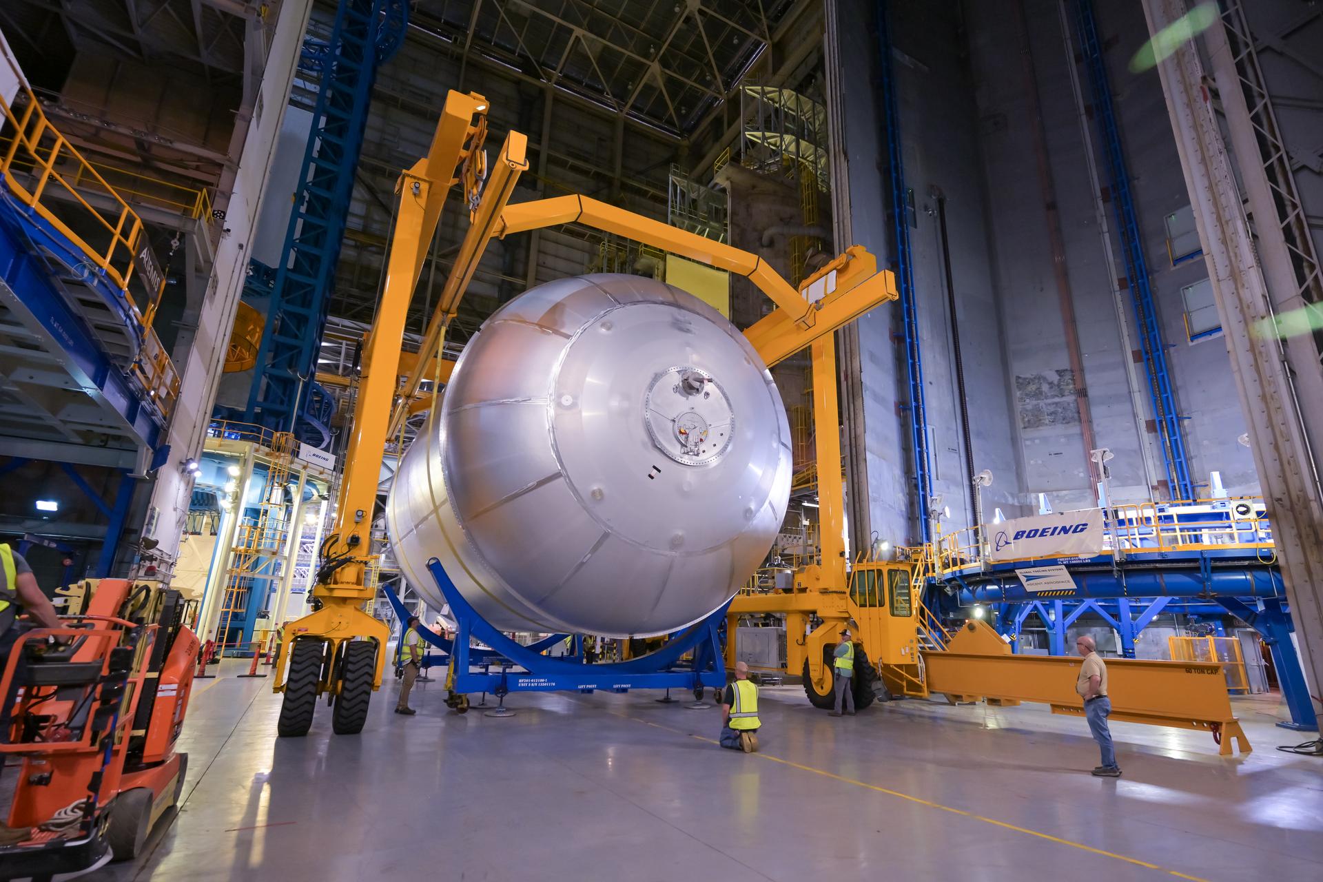 Teams at NASA’s Michoud Assembly Facility in New Orleans move a liquid oxygen tank from the main rocket factory into the adjacent vertical assembly building. The liquid oxygen tank, which will form part of the SLS (Space Launch System) rocket for NASA’s Artemis IV mission to the Moon, is rotated from a horizontal to a vertical configuration and loaded into the high bay’s hydrostatic proof testing cell. This non-destructive evaluation method tests the structural integrity of the tank’s welds by filling the tank with water, simulating the propellant used during launch. The propellant tank will hold more than 196,000 gallons of super-cooled liquid oxygen at launch and is one of five major elements that make up the 212-foot-tall SLS rocket stage. The core stage, along with its four RS-25 engines at its base, produces more than two million pounds of thrust to help launch NASA’s Orion spacecraft, astronauts, and supplies beyond Earth’s orbit and to the lunar surface for Artemis.